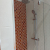 Full-Width-Shower-With-Orange-Glass-Mosaics