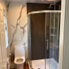 Nuance-Natural-Greystone-And-Calacatta-Statuario-Shower-Panels