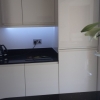 Luxury Handle Less Fitted Kitchen With Solid Worktops